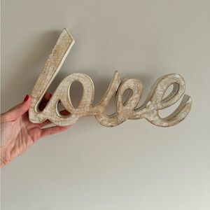 Distressed wooden “love” sign decor